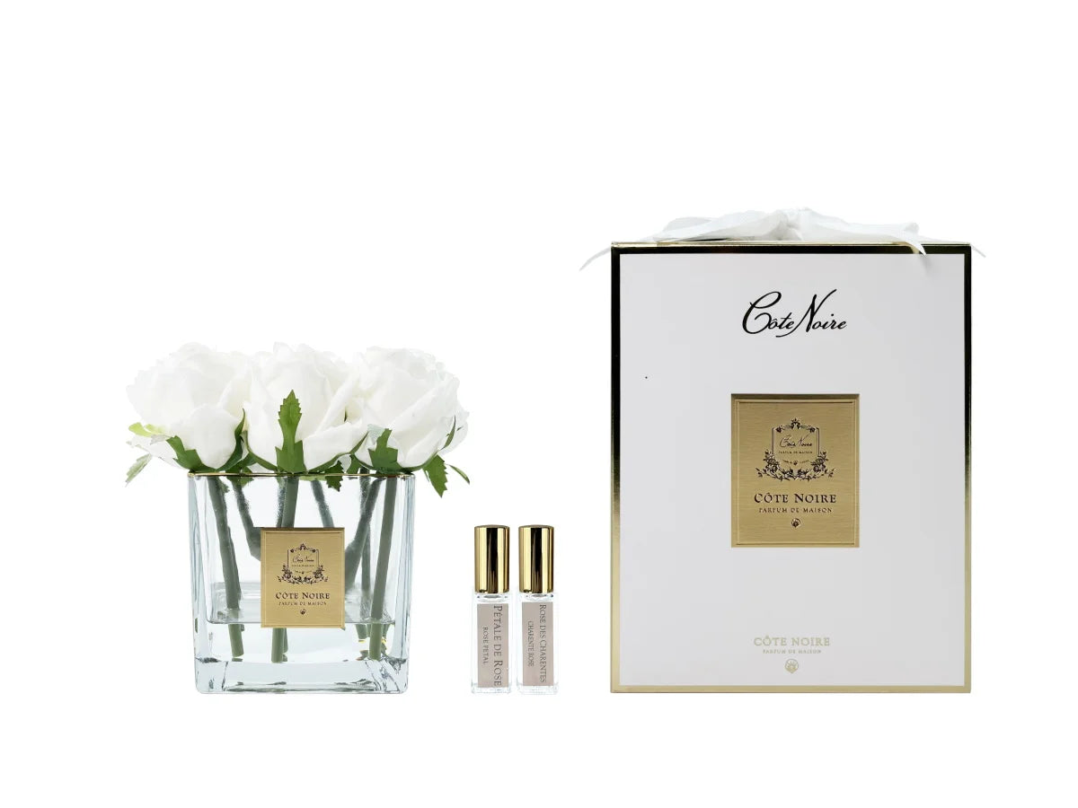 موزّع عطر 9 وردات بيضاء في وعاء شفاف